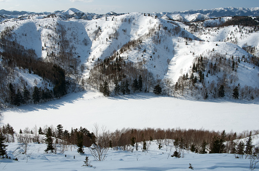 Winter lake under ice and white snow among the hills, Sakhalin island