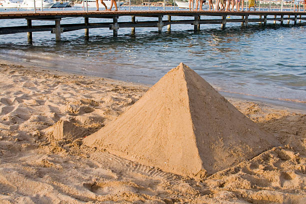 pyramid in sand castle - pyramid shaped stock-fotos und bilder