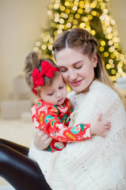 istock Mother and daughter near Christmas tree 1789984323