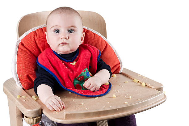 toddler eating potatoes stock photo