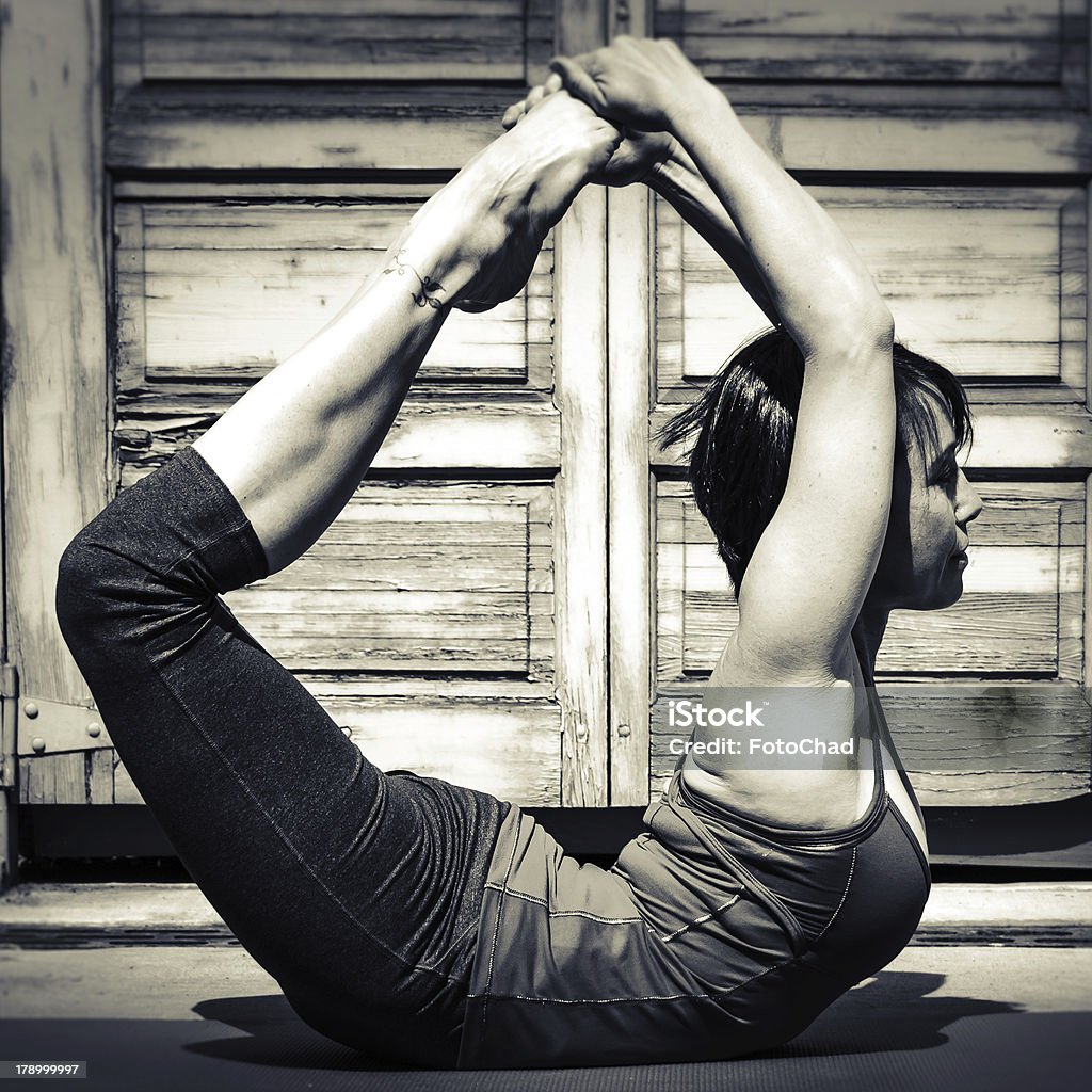 Woman in Danurasana Yoga Pose Black and white square image of a woman in danurasana yoga pose. Black And White Stock Photo