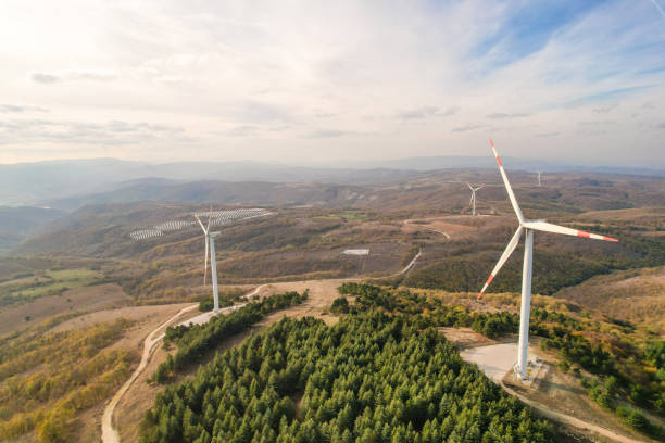 istock Wind turbines and solar panels in the forest area 1790005542