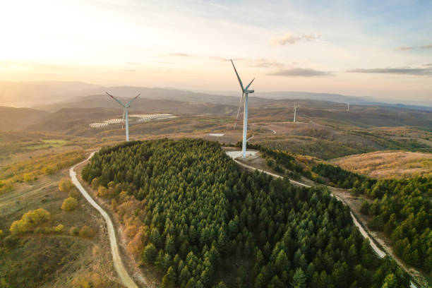 istock Wind turbines and solar panels in the forest area 1790006108