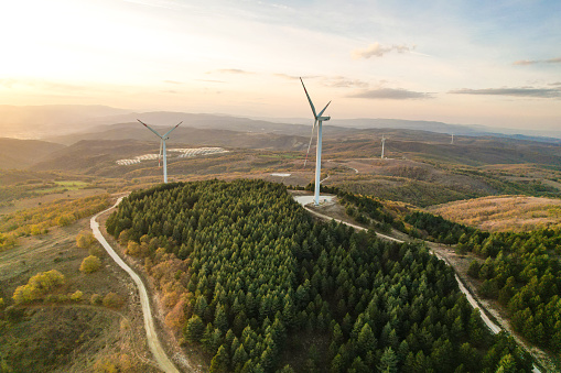 Wind turbines and solar panels in the forest area