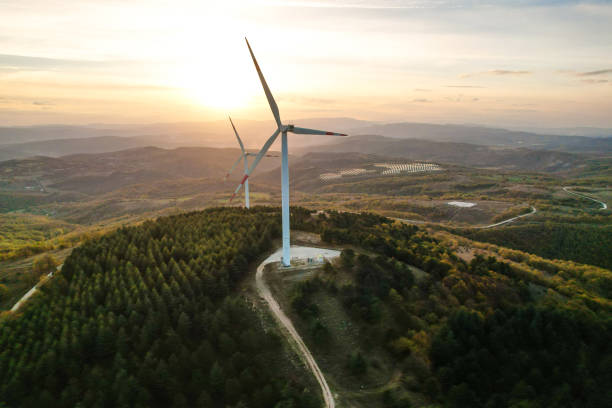 istock Wind turbines and solar panels in the forest area 1790008216