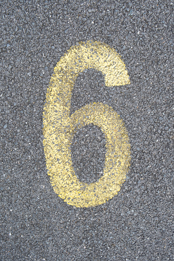 the number 6 six are drawn with color paint on asphalt. a children's playground designed a creative display of the alphabet educational element learning space.