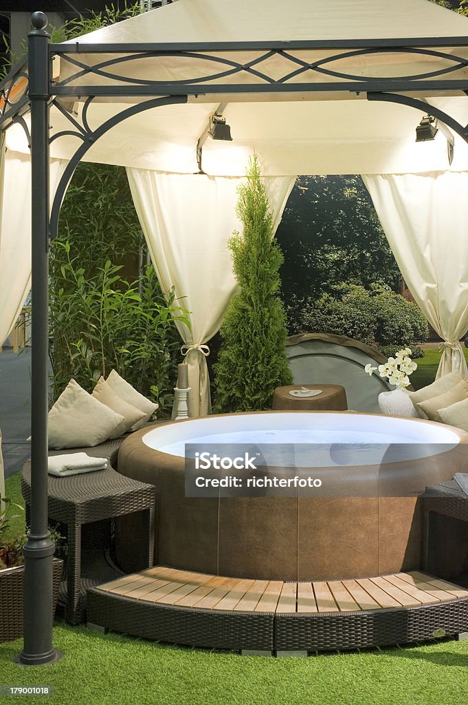 Covered hot tub in a garden Covered hot tub in a garden. Hot Tub Stock Photo