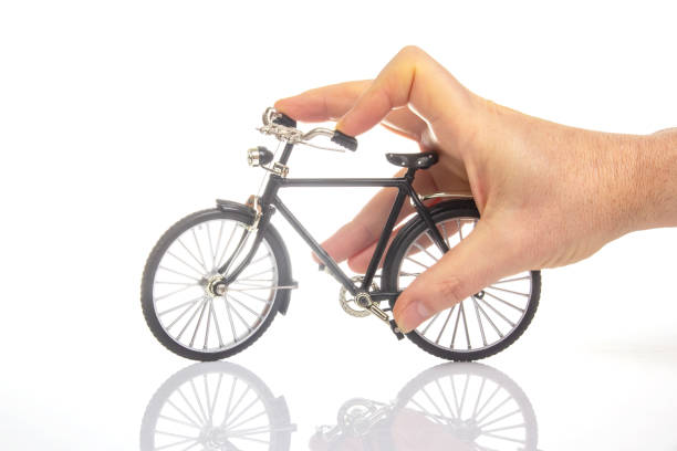 istock man hand on a bicycle model on a white background. cycling concept 1790012016