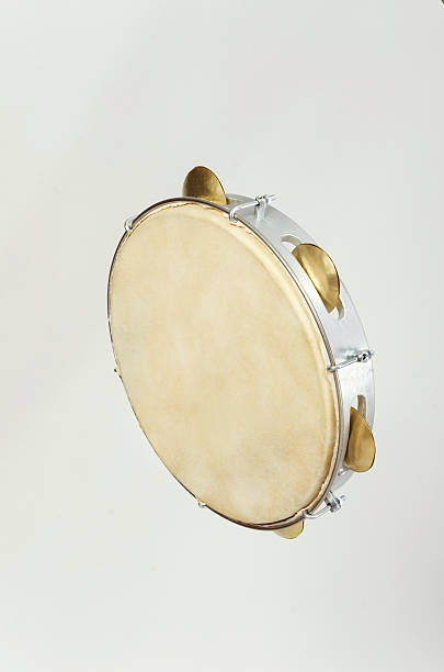 istock Silver and gold tambourine on light grey background 179001376
