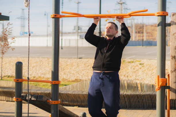istock a handsome healthy athletic guy doing callsthenics pull-ups outdoor on a sports ground 1790015294