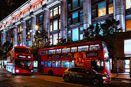Oxford Street, Central London, England, United Kingdom, Britain - November 2023: Selfridges on Oxford Street (Europe's busiest shopping hub & luxury retail high street in the UK),  Christmas Shopping, Christmas lights, and Double-decker buses on the road Around the \