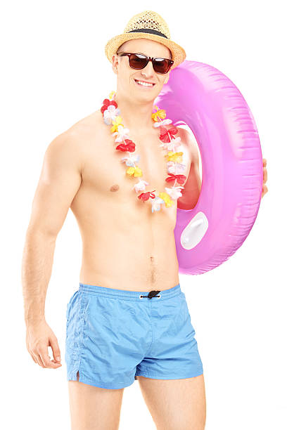 istock Shirtless fit guy holding a pink swimming ring 179001921