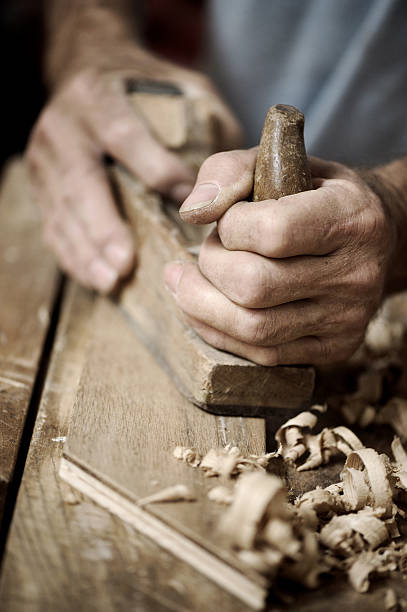 istock Man hands with carpenter's plane on wooden background 179002076