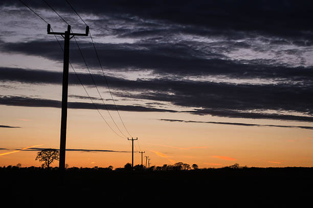 istock Fading Power Lines in Sunset with Clouds on the Horizon 179002596