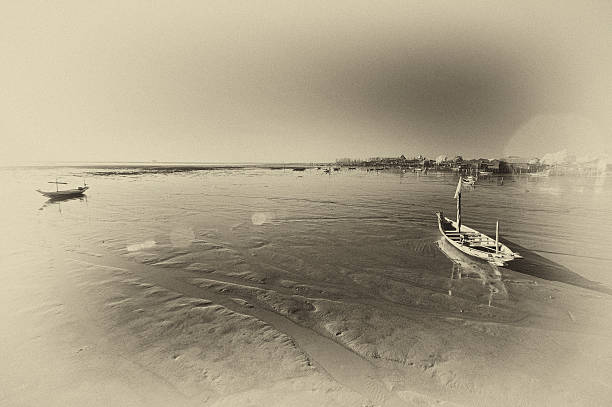 Wrecked boat at receding shore