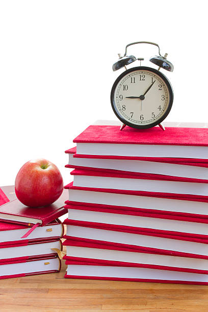 istock alarm clock and books on a table 179003066