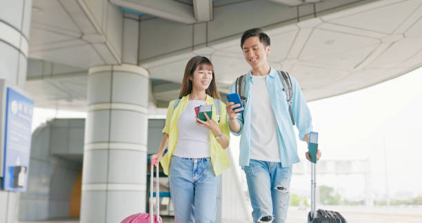 istock Couple walk chat at airport 1790033119