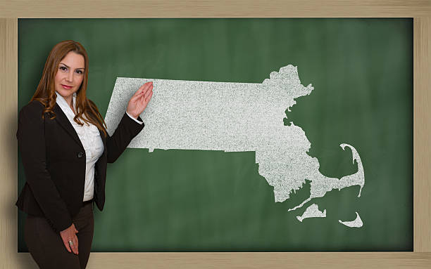 istock Teacher showing map of massachusetts on blackboard 179004070
