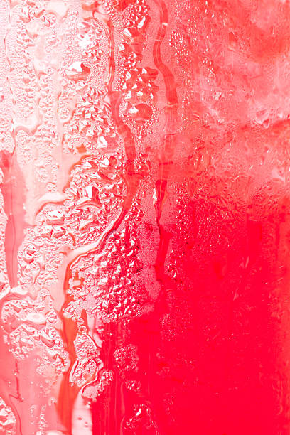 istock Glass surface of red water with ice cubes background 179004256