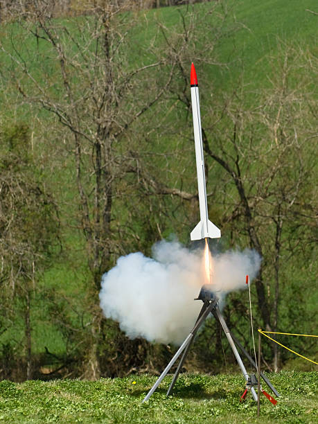 Flames and Smoke During Blastoff Model rocket launches off the launchpad with copious amounts of smoke and flame emitting from its engine. model rocket stock pictures, royalty-free photos & images