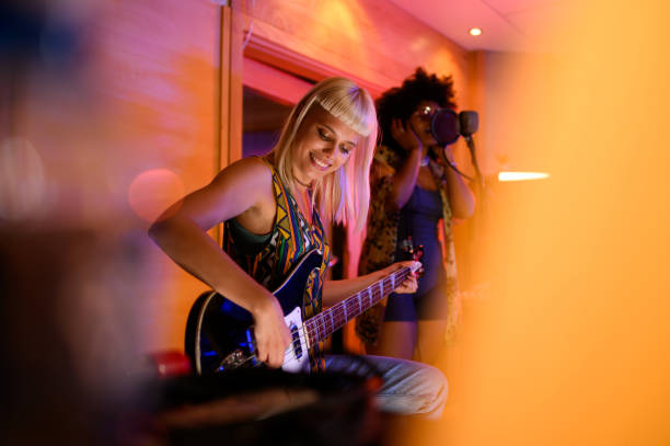 istock Female guitar player and singer in a recording studio, multicultural. 1790065581