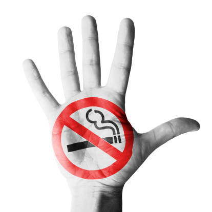 Hand raised with no smoking symbol painted - isolated on white background