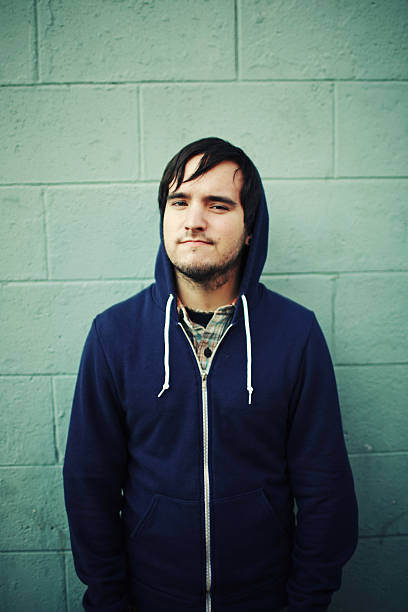istock Young Man in Hoodie on Green Brick Wall 179006918