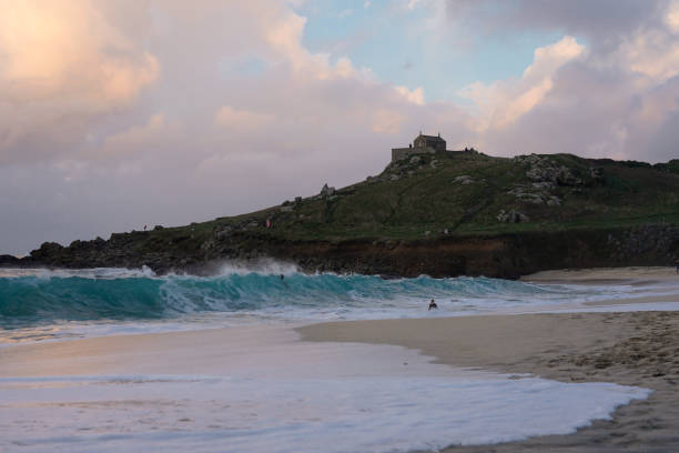 Island in the background, cloudy sky and large waves