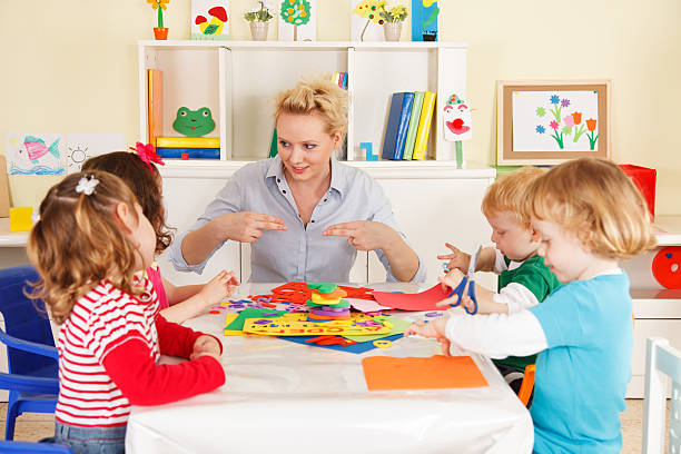 istock Pre-school children in the classroom with a teacher 179008278