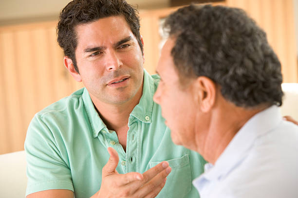 istock Two men in living room arguing 179008443