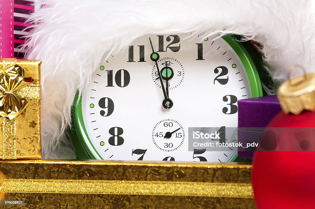 Alarm clock with santa hat Alarm clock with christmas santa hat, isolated on white background Black Color Stock Photo