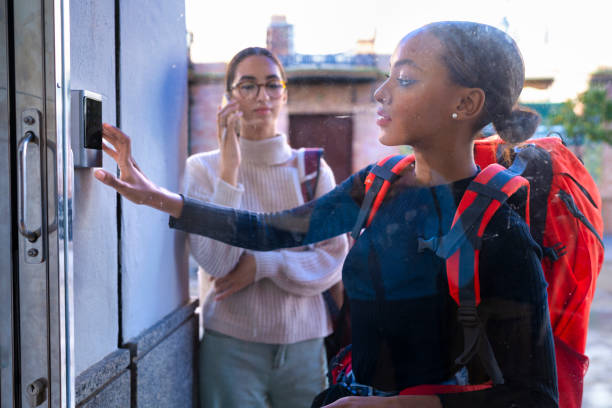 istock Two digital nomadic girls enter the code they have obtained on their mobile phone to enter a coworking center to work 1790091685