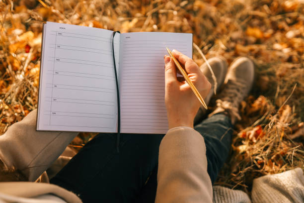 istock Girl with paper planner outdoors, autumn concept 1790105019