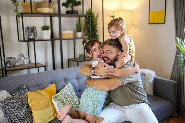istock Young active dad play with daughters in modern room stock photo 1790107003