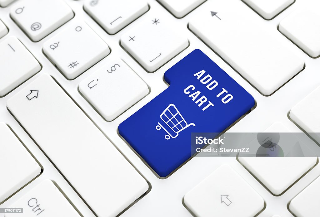 Shop add to cart business concept. Shopping key on keyboard Shop on line add to cart business concept, Blue shopping cart button or key on white keyboard photography. Backgrounds Stock Photo