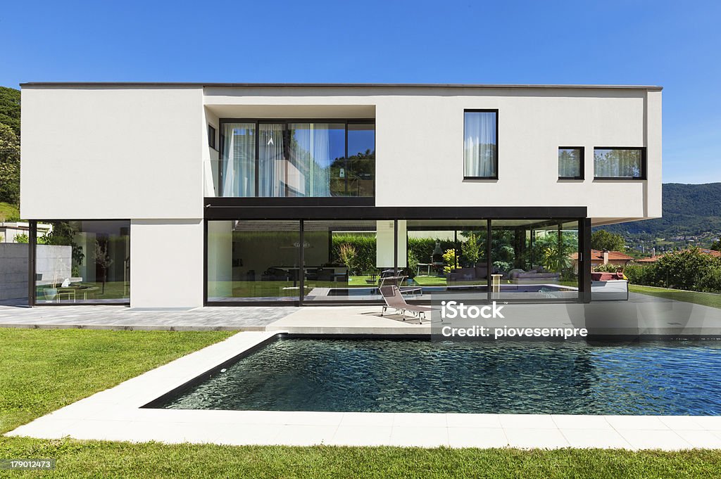 Modern villa with pool Modern villa with pool, view from the garden Swimming Pool Stock Photo