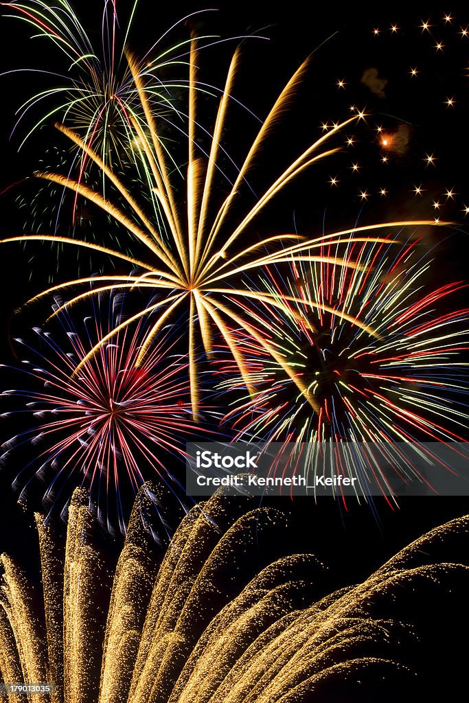 Fireworks Extravaganza The night sky is lighted with a fireworks dispay featuring a wide variety of types and colors in great detail Firework - Explosive Material Stock Photo