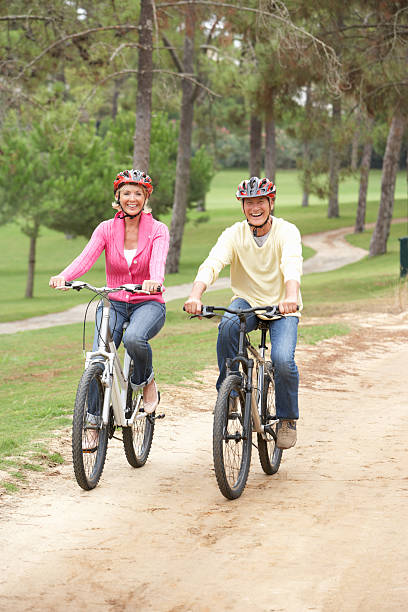 istock Senior couple riding bicycle in park 179013807