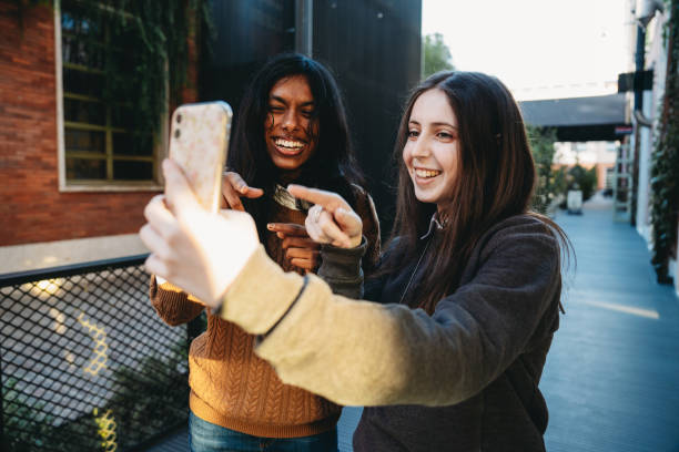 istock Two friends are having fun together with a mobile phone 1790139635