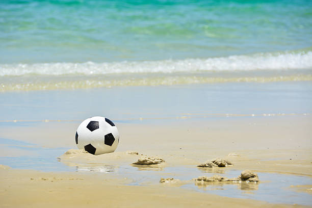 istock Football on the beach 179013988