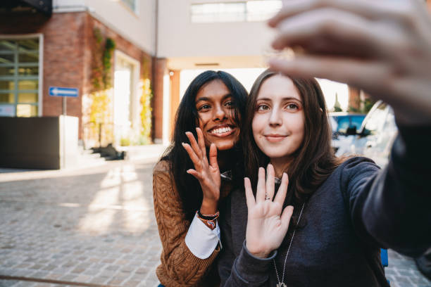 istock Two friends are making a video call while they are sitting at a table in the city 1790141237