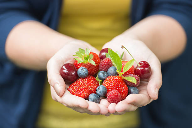 istock girl holding fruits 179014280