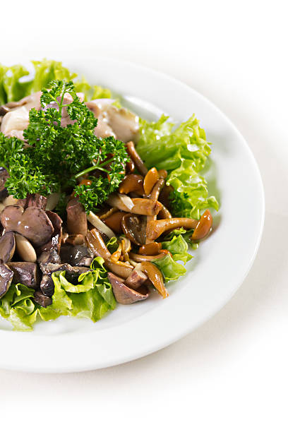 plate with mushrooms salad greens stock photo