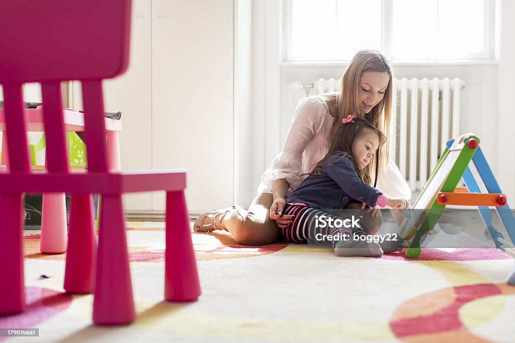 Mother and daughter drawing in the room Activity Stock Photo