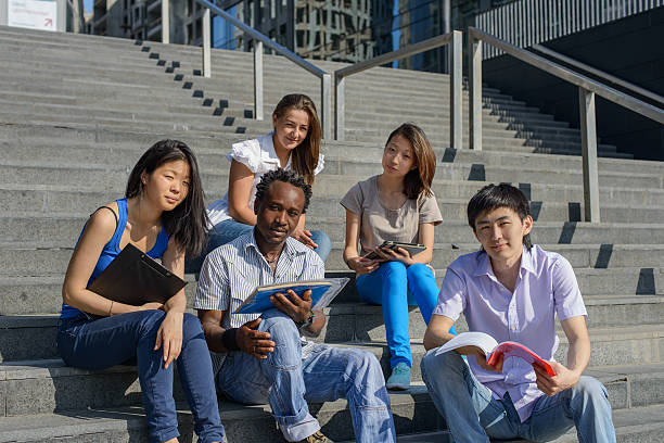 istock Multiethnic group of university students sitting on steps 179015110