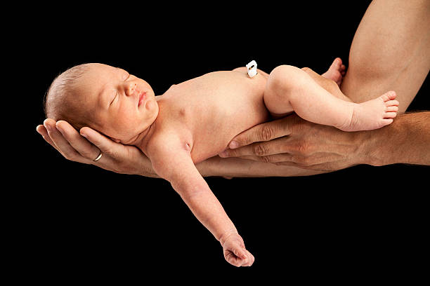 istock Newborn boy lying on his dad's arms 179015162
