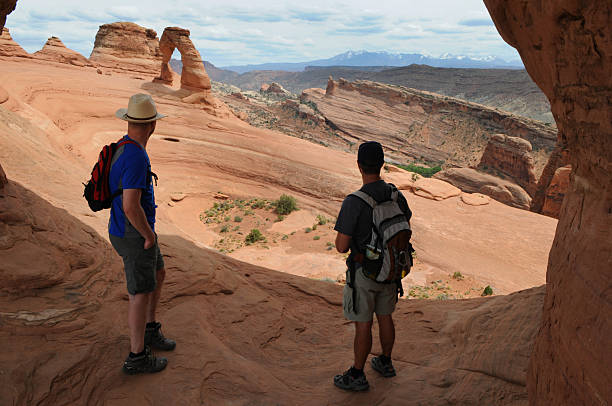 istock Two Hikers at the Delicate Arch 179015723
