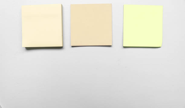istock Blank three grey colorful sticky notes on green background. Place for text. Stationery template.Copy space. Sticky note stuck in the middle 1790163008