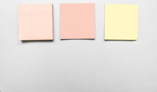 istock Blank three grey colorful sticky notes on green background. Place for text. Stationery template.Copy space. Sticky note stuck in the middle 1790163015
