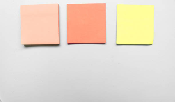 istock Blank three grey colorful sticky notes on gray background. Place for text. Stationery template.Copy space. Sticky note stuck in the middle 1790165115